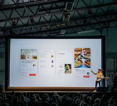 Speaker presenting decentralized clinical trial data to a conference audience