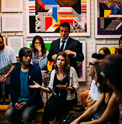 Panelists speaking to a seated audience at a drug discovery conference
